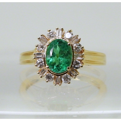 2770 - AN 18CT EMERALD & DIAMOND RINGset with an oval cut emerald of 7mm x 5.6mm, with brilliant and ba... 