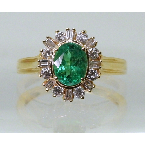 2770 - AN 18CT EMERALD & DIAMOND RINGset with an oval cut emerald of 7mm x 5.6mm, with brilliant and ba... 