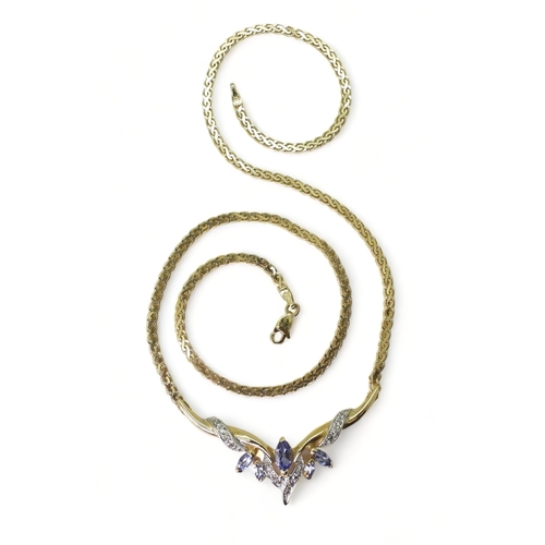 2772 - A TANZANITE AND DIAMOND NECKLACEmounted in 14k gold, largest tanzanite 7mm x 3.5mm, with grain set d... 