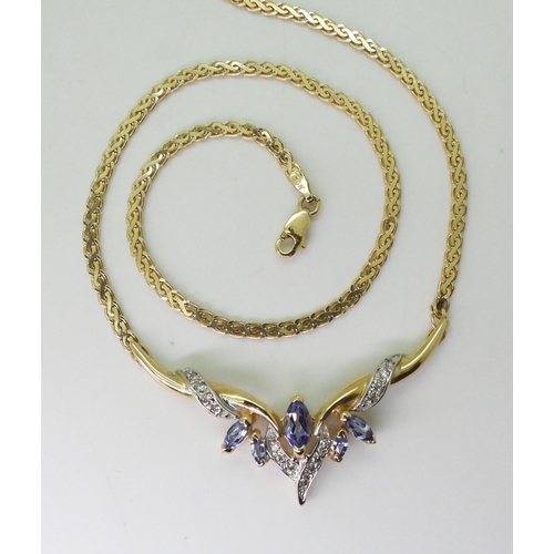 2772 - A TANZANITE AND DIAMOND NECKLACEmounted in 14k gold, largest tanzanite 7mm x 3.5mm, with grain set d... 