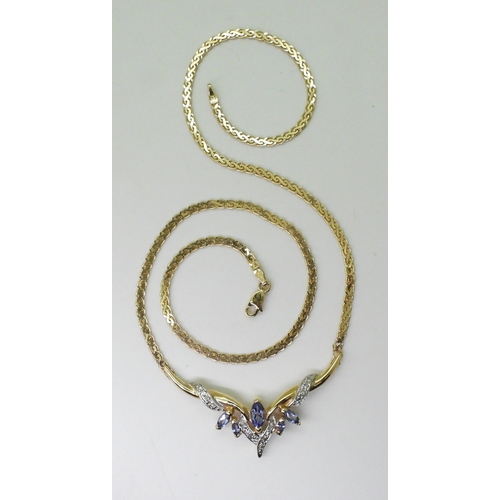 2772 - A TANZANITE AND DIAMOND NECKLACEmounted in 14k gold, largest tanzanite 7mm x 3.5mm, with grain set d... 