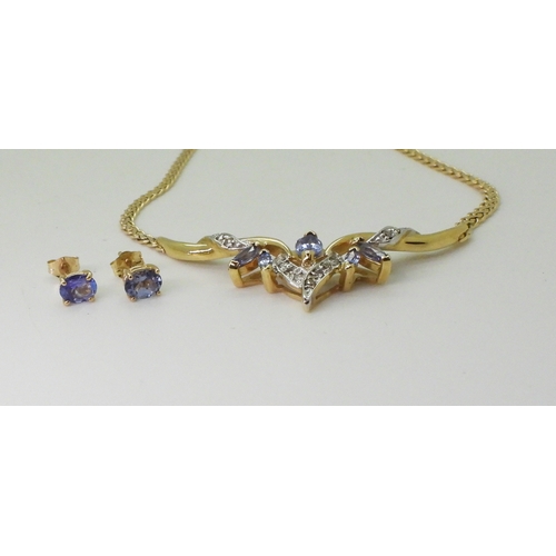 2772 - A TANZANITE AND DIAMOND NECKLACEmounted in 14k gold, largest tanzanite 7mm x 3.5mm, with grain set d... 