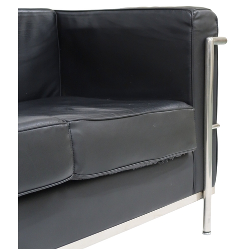 2099 - A 20TH CENTURY AFTER LE CORBUSIER THREE SEATER SETTEE with black vinyl cushions on chromed tubu... 