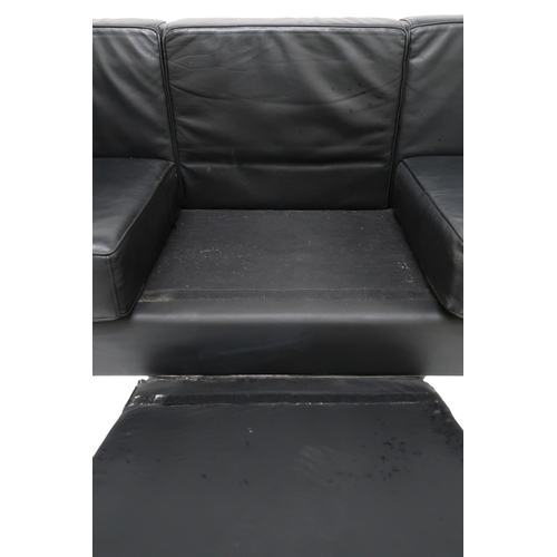 2099 - A 20TH CENTURY AFTER LE CORBUSIER THREE SEATER SETTEE with black vinyl cushions on chromed tubu... 