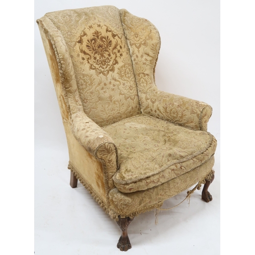 2016 - AN EARLY 20TH CENTURY GEORGIAN STYLE WINGBACK ARMCHAIR with Damask upholstery on carved lions p... 