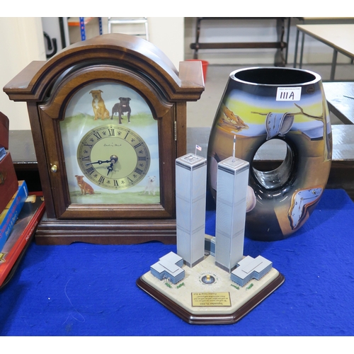 111A - A Goebel Dali glass vase, a Danbury Mint Staffordshire Bull Terrier clock and a Twin Towers sculptur... 