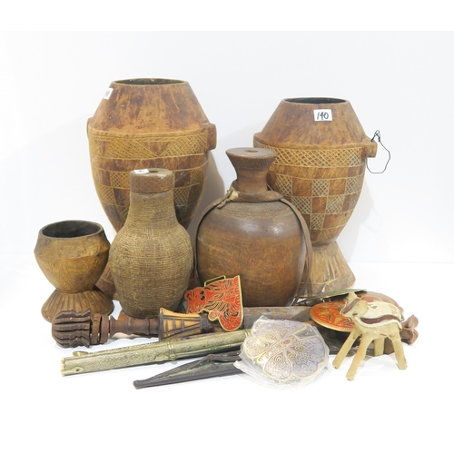 140 - Two African wooden storage vessels, a shagreen covered knife, African woven water vessels etc