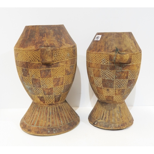 140 - Two African wooden storage vessels, a shagreen covered knife, African woven water vessels etc