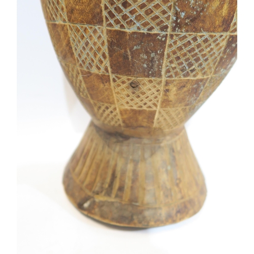 140 - Two African wooden storage vessels, a shagreen covered knife, African woven water vessels etc