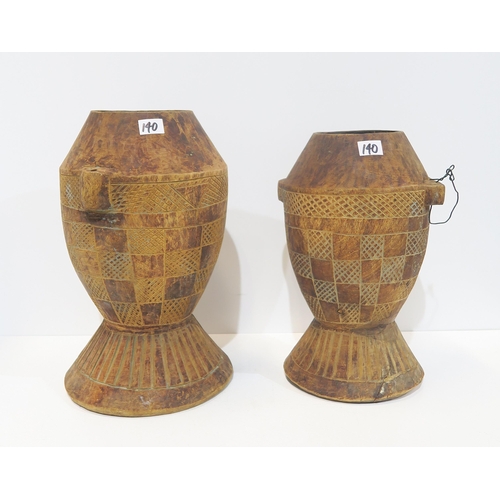 140 - Two African wooden storage vessels, a shagreen covered knife, African woven water vessels etc