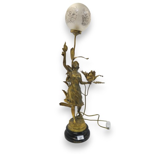 121 - After E Rousseau, a gilded spelter lamp modelled as a maiden holding a flower in one hand and a flam... 