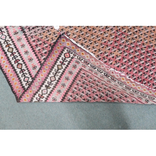 20 - A pink ground Malayer runner with multicoloured borders, 260cm long x 134cm wide 