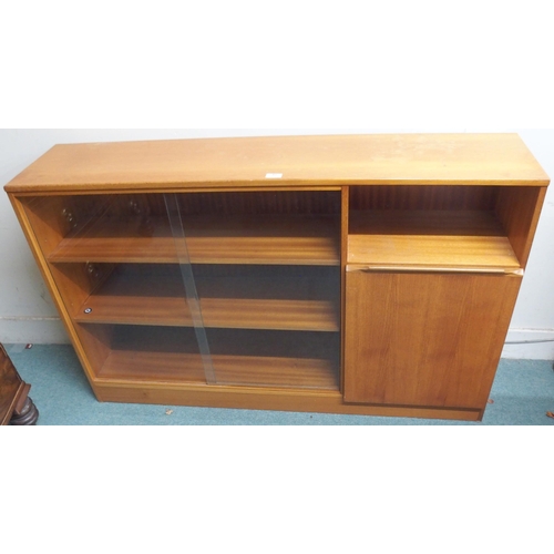 61 - A mid 20th century teak bookcase with pair of glass sliding doors alongside cabinet door, 86cm high ... 