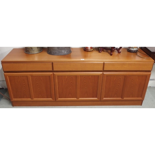 63 - A mid 20th century teak sideboard with three drawers over three cabinet doors, 69cm high x 181cm wid... 