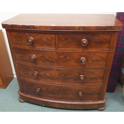 72 - A late Victorian mahogany bow front two over three chest of drawers on bun feet, 107cm high x 117cm ... 