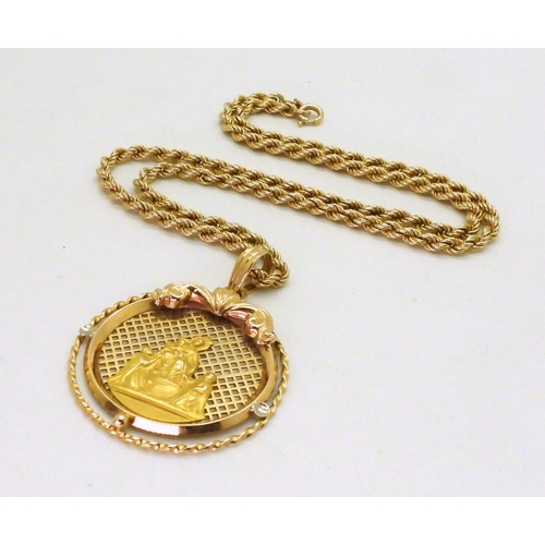 710 - An 18ct gold Holy medal diameter 3.5cm, together with a 43cm, 18ct gold rope chain, weigh together 1... 