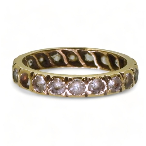 770 - An 18ct gold full eternity ring set with synthetic spinels, finger size M1/2, weight 2.7gms