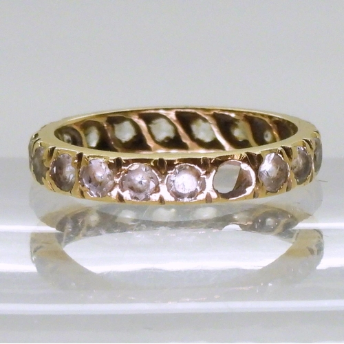 770 - An 18ct gold full eternity ring set with synthetic spinels, finger size M1/2, weight 2.7gms