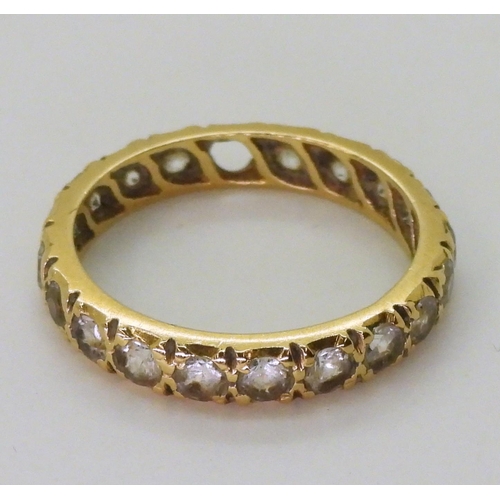 770 - An 18ct gold full eternity ring set with synthetic spinels, finger size M1/2, weight 2.7gms