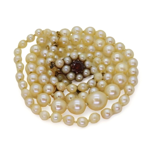 778 - A string of Ciro cultured pearls with a 9ct gold garnet and pearl clasp, length 46cm, weight 12gms