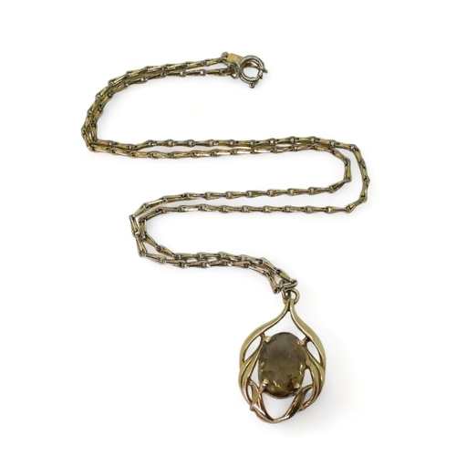 781 - A 9ct gold smoky quartz pendant with a gold plated Monet chain, weight of the pendant approx 3.8gms