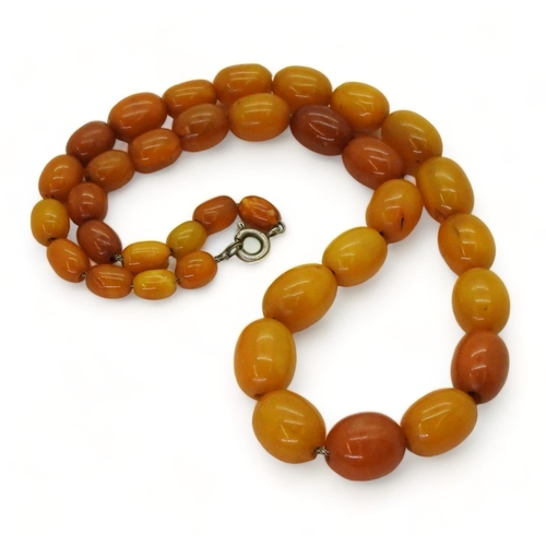 827 - A string of yellow and orange amber coloured beads, largest bead approx 11mm x 13.6gms, overall leng... 