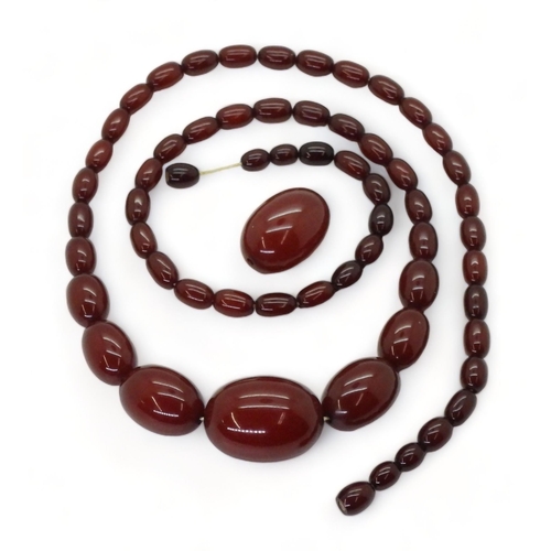 828 - A long string of cherry amber coloured beads, and one loose bead, length 77cm, weight all together 5... 