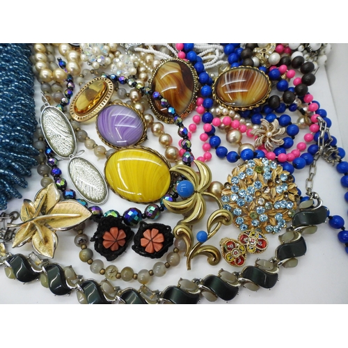 830 - A large collection of costume jewellery to include a string of Cherry amber coloured beads, (weight ... 