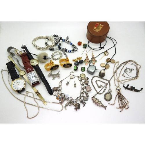 834 - A silver charm bracelet with fifteen silver and white metal charms to include enamel examples, a 'Te... 