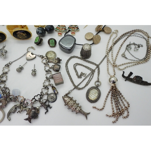 834 - A silver charm bracelet with fifteen silver and white metal charms to include enamel examples, a 'Te... 