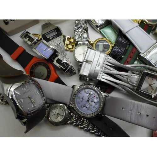 845 - A large collection of ladies fashion watches, to include, a mother of pearl dial Skagen watch, a Lor... 