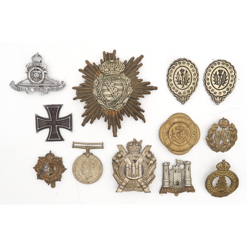 517 - An Imperial German Saxony pickelhaube or busby plate, a WW1-period Iron Cross, assorted military cap... 