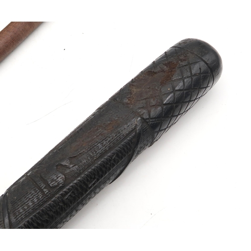 521 - An Irish bog oak truncheon, with carved shamrock decoration, measuring approx. 40cm in length, toget... 