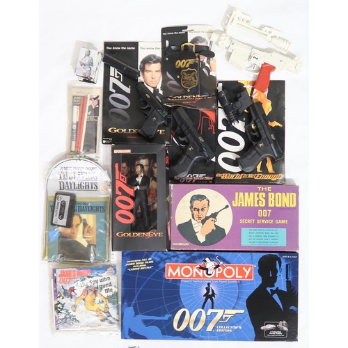 561 - A large and varied selection of James bond collectables, to include a replica Octopussy Number One's... 