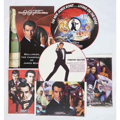 570 - JAMES BONDA collection of prints, books and magazines on Bond, to include two circular carboard spin... 