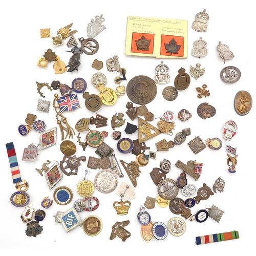 598 - A large and varied assortment of militaria, to include WW1-period Canadian Expeditionary Forces badg... 