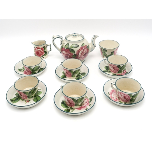 2247 - A WEMYSS WARE TEASETpainted with cabbage roses, comprising teapot, six cups and saucers, milk jug an... 