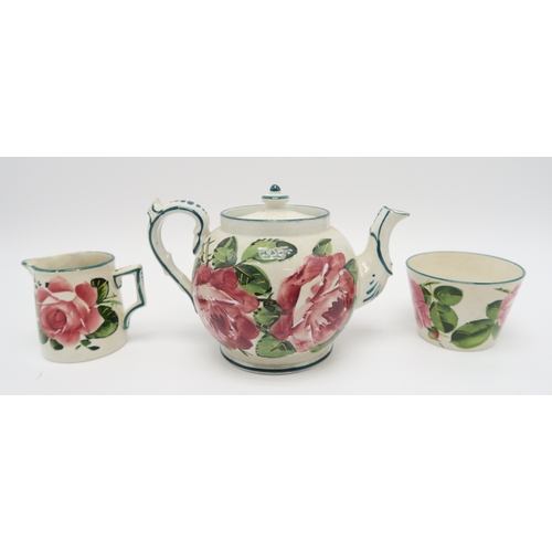 2247 - A WEMYSS WARE TEASETpainted with cabbage roses, comprising teapot, six cups and saucers, milk jug an... 