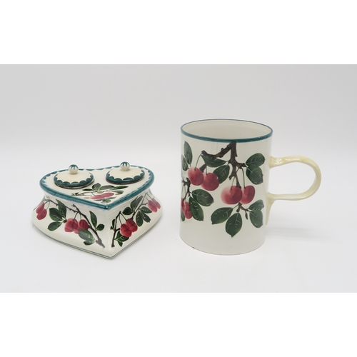 2248 - A WEMYSS WARE CHERRY DECORATED HEART SHAPED INKWELLtogether with a large tankard 14.5cm high (2)... 