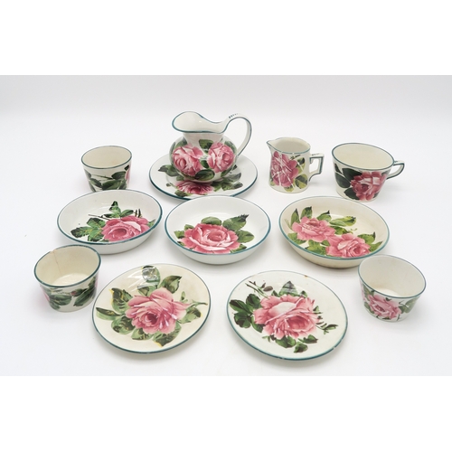 2251 - A COLLECTION OF WEMYSS WAREall painted with cabbage roses, including a cup and saucer, two other sau... 