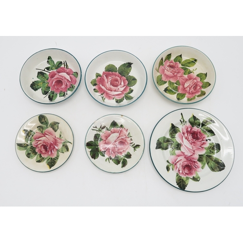 2251 - A COLLECTION OF WEMYSS WAREall painted with cabbage roses, including a cup and saucer, two other sau... 