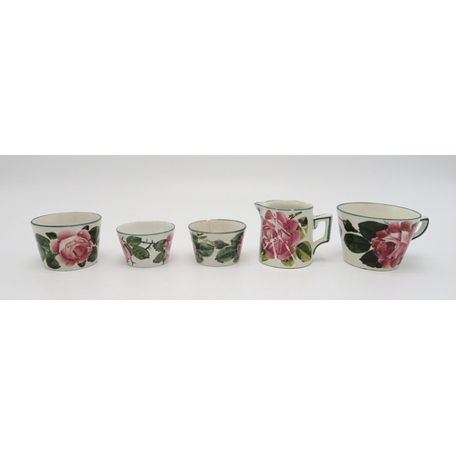 2251 - A COLLECTION OF WEMYSS WAREall painted with cabbage roses, including a cup and saucer, two other sau... 