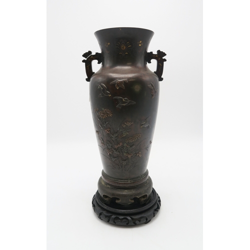 2382 - A JAPANESE BRONZE TWO HANDLED VASECast and decorated with birds amongst peonies,magnolia and chrysan... 