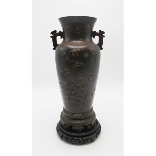 2382 - A JAPANESE BRONZE TWO HANDLED VASECast and decorated with birds amongst peonies,magnolia and chrysan... 