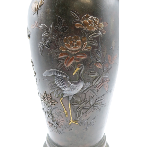 2382 - A JAPANESE BRONZE TWO HANDLED VASECast and decorated with birds amongst peonies,magnolia and chrysan... 