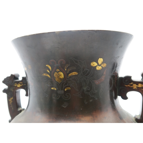 2382 - A JAPANESE BRONZE TWO HANDLED VASECast and decorated with birds amongst peonies,magnolia and chrysan... 