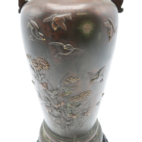 2382 - A JAPANESE BRONZE TWO HANDLED VASECast and decorated with birds amongst peonies,magnolia and chrysan... 