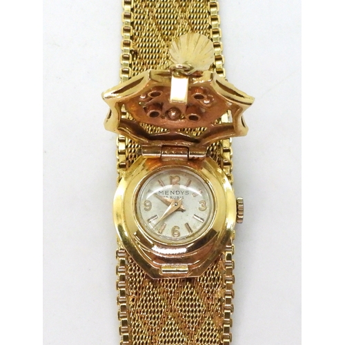 2912 - A MENDY'S 18K COCKTAIL WATCH with decorative mesh strap and a gem set and tasseled dial cover. lengt... 