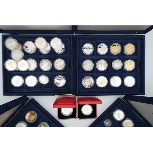 348 - ELIZABETH II A lot comprising 60 assorted silver proof coins in four collectors cases... 