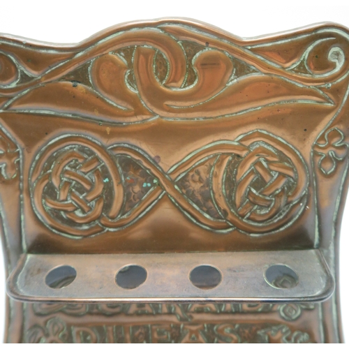 2223 - AN ALEXANDER RITCHIE OF IONA COPPER PIPE RACKwith repousse decoration of Celtic knotwork and stylise... 